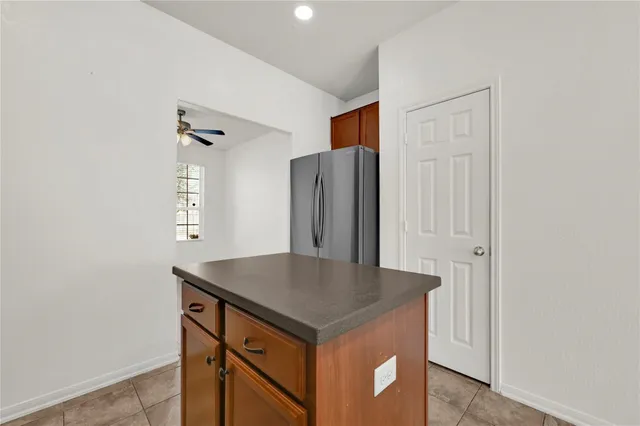 a kitchen with stainless steel appliances cabinets and wooden floor