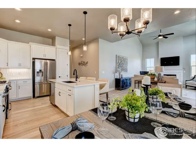 a kitchen with kitchen island a sink stainless steel appliances and cabinets
