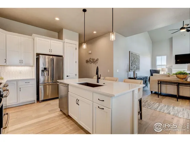 a kitchen with granite countertop white cabinets and appliances