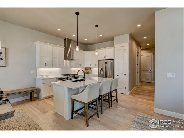 a view of a house with pool and chairs