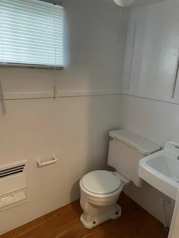 a white toilet sitting next to a bathroom sink