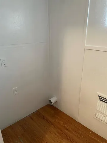 a view of a room with wooden floor