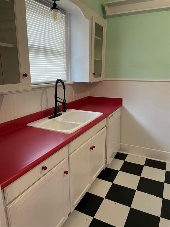 2257 College Avenue Fort Worth, TX 76110 - Photo 20 of 26 a kitchen with a sink a refrigerator and cabinets