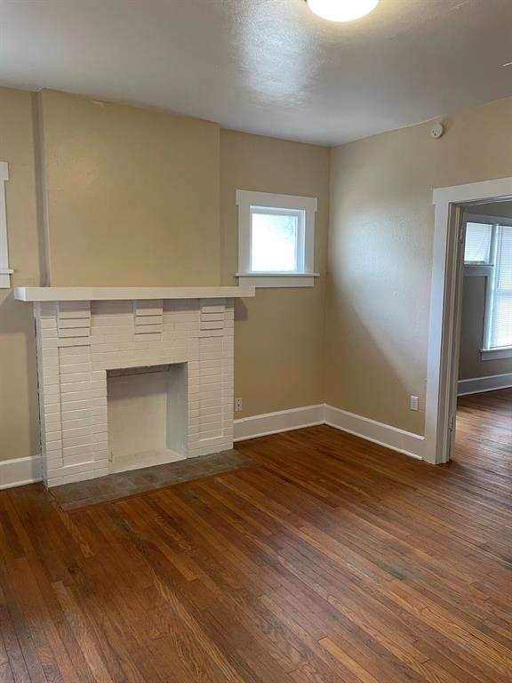 2257 College Avenue Fort Worth, TX 76110 - Photo 2 of 26 a view of empty room with wooden floor and fireplace