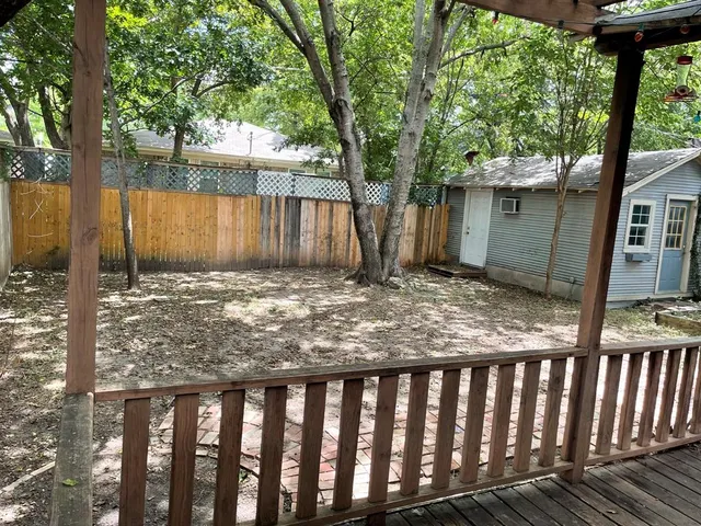 a view of a backyard with large trees