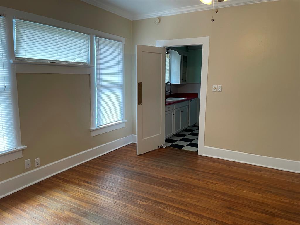 2257 College Avenue Fort Worth, TX 76110 - Photo 5 of 26 an empty room with wooden floor and closet