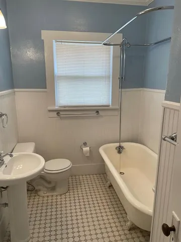 a bathroom with a sink a toilet and bathtub
