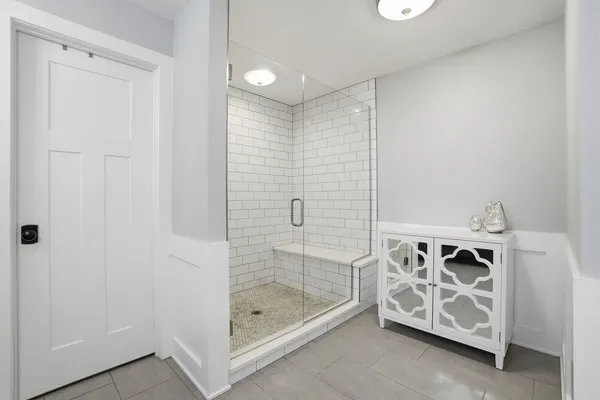 a bathroom with a double vanity sink toilet and shower
