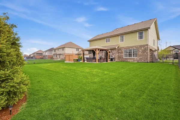 an aerial view of a house with a yard