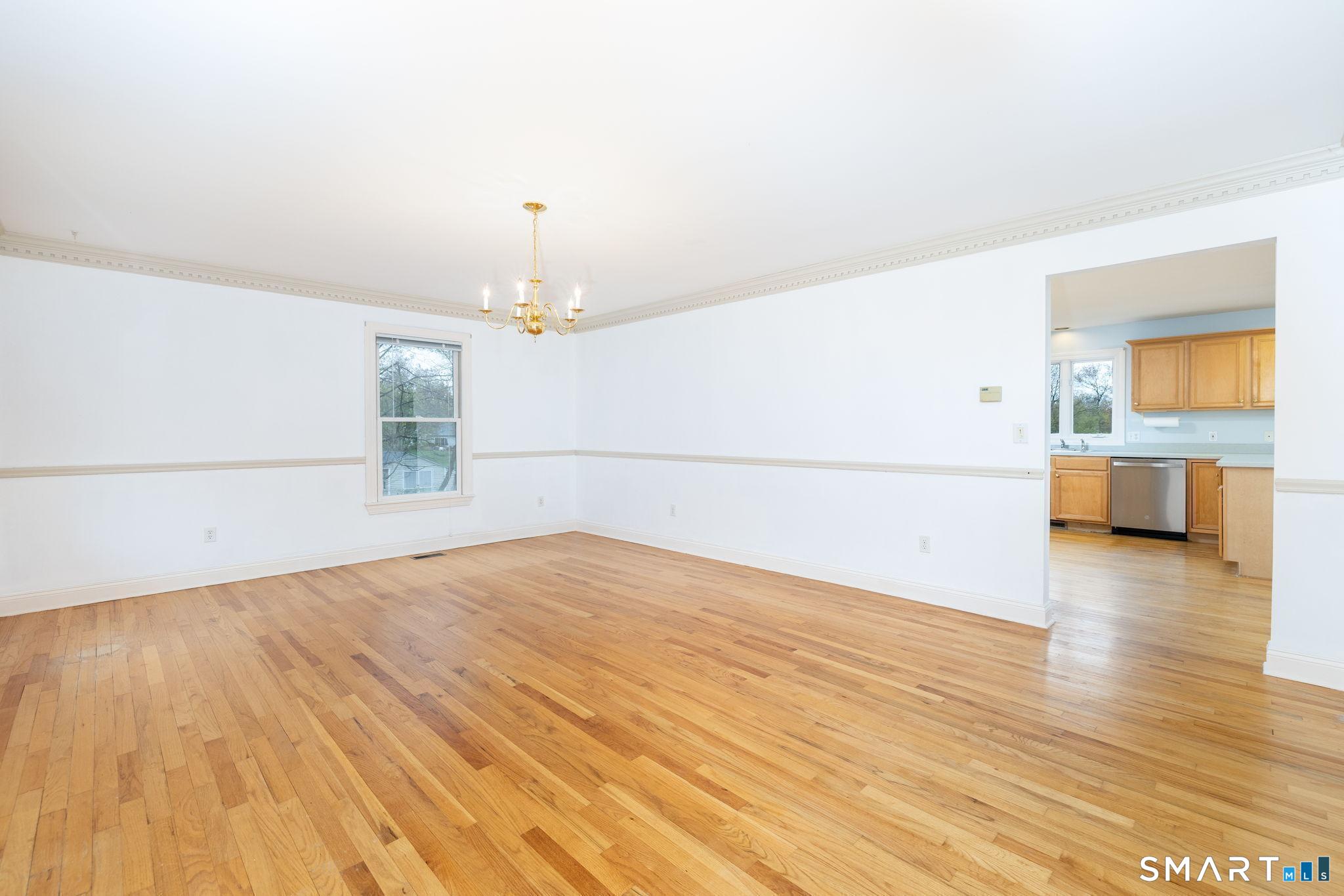 1057 Daniels Farm Road Trumbull, CT 06611 - Photo 16 of 40 a view of a livingroom with wooden floor and a refrigerator