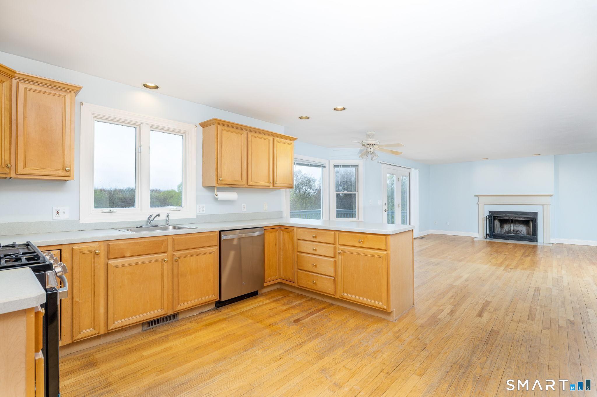 1057 Daniels Farm Road Trumbull, CT 06611 - Photo 17 of 40 a large kitchen with stainless steel appliances granite countertop a stove a sink and a microwave