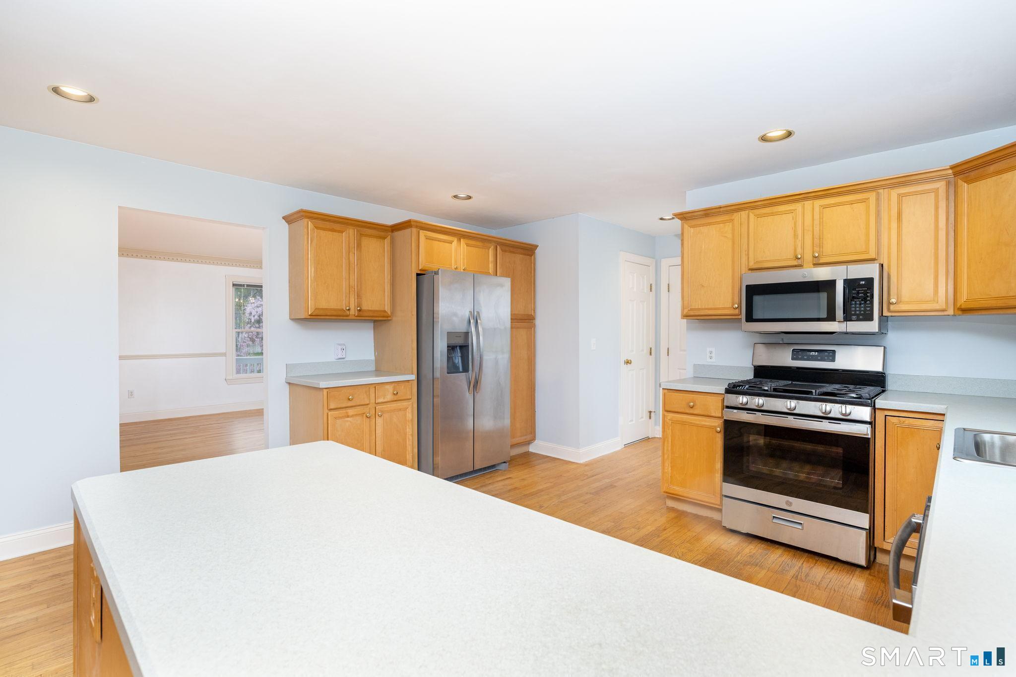 1057 Daniels Farm Road Trumbull, CT 06611 - Photo 19 of 40 a kitchen with stainless steel appliances a stove and a refrigerator