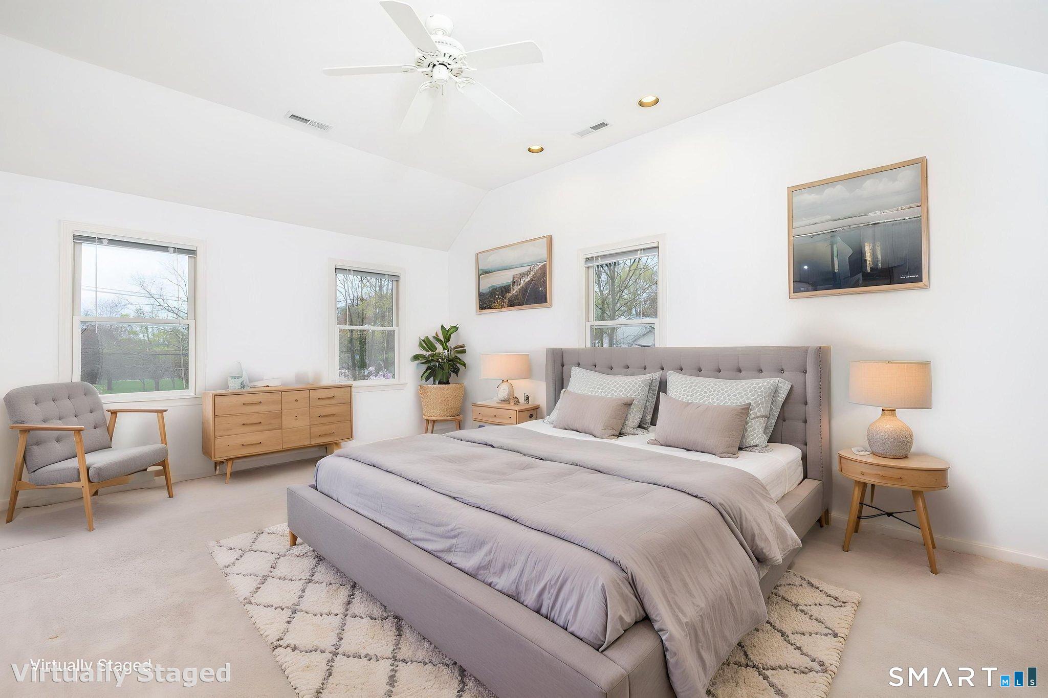 1057 Daniels Farm Road Trumbull, CT 06611 - Photo 26 of 40 a spacious bedroom with a bed a couch and a window