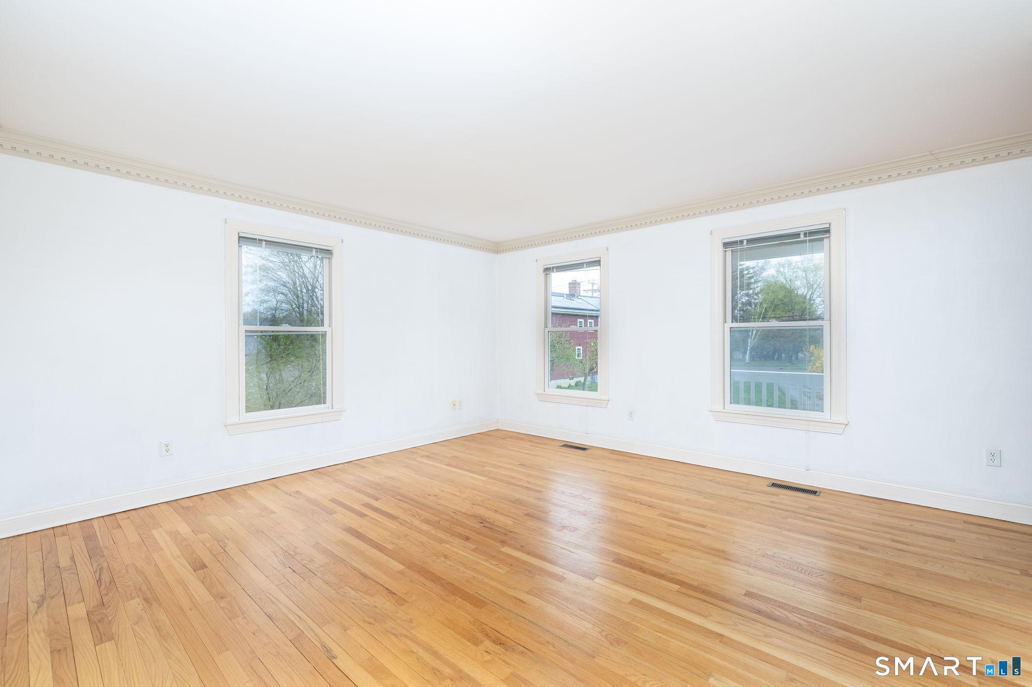 1057 Daniels Farm Road Trumbull, CT 06611 - Photo 9 of 40 a view of an empty room with wooden floor and a window