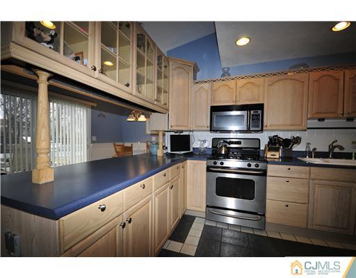 33 Sturgis Road Edison, NJ 08817 - Photo 3 of 10 a kitchen with stainless steel appliances granite countertop a sink a stove and cabinets