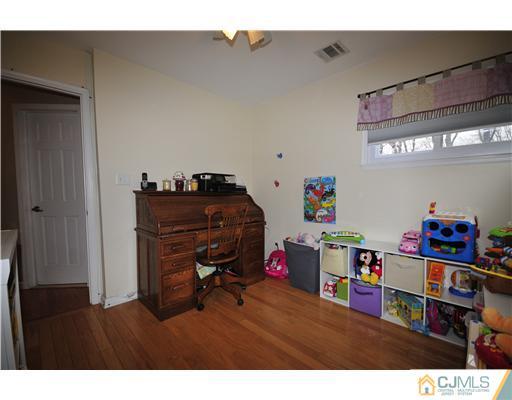33 Sturgis Road Edison, NJ 08817 - Photo 8 of 10 a bedroom with furniture and a chandelier