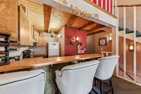 a dining table chair next to a window
