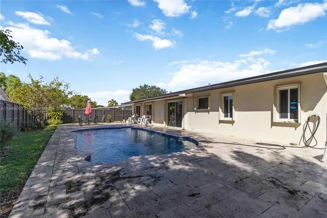 a view of a house with backyard and sitting area