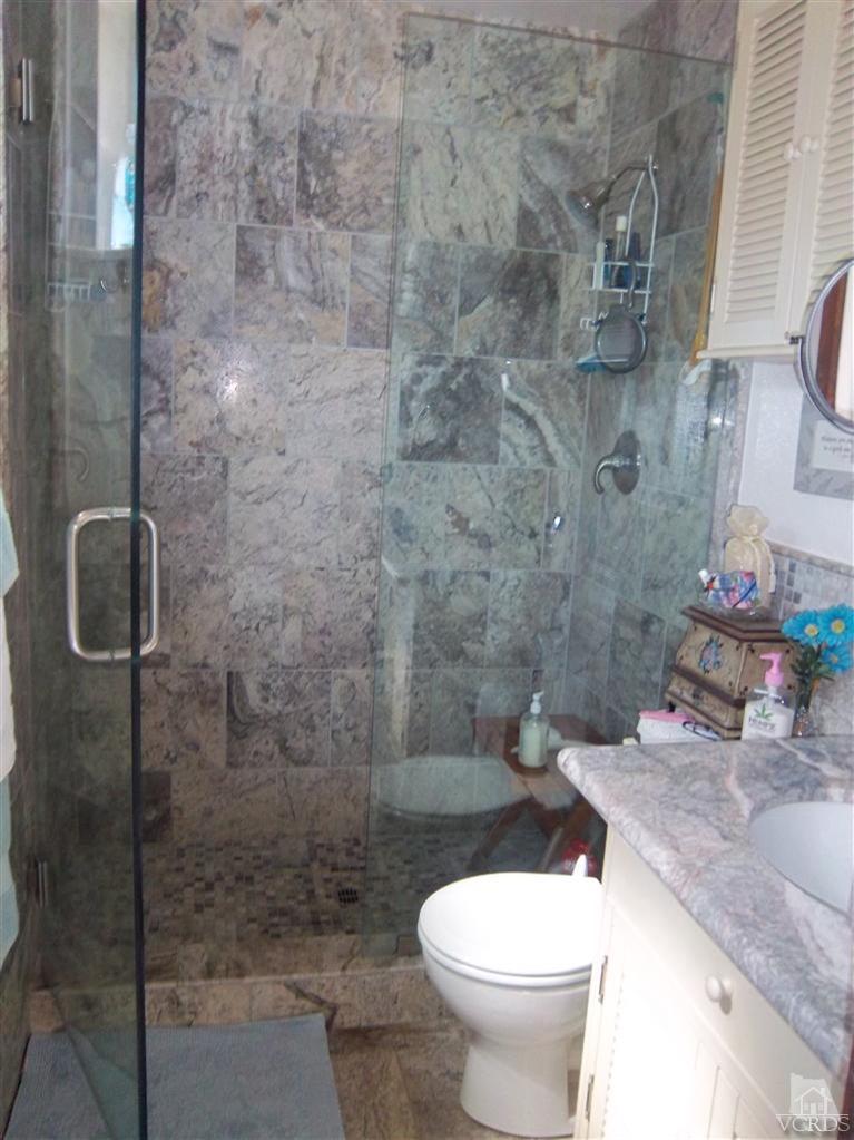 13520 East Quail Summit Road Moorpark, CA 93021 - Photo 4 of 20 a bathroom with a granite countertop toilet and a sink