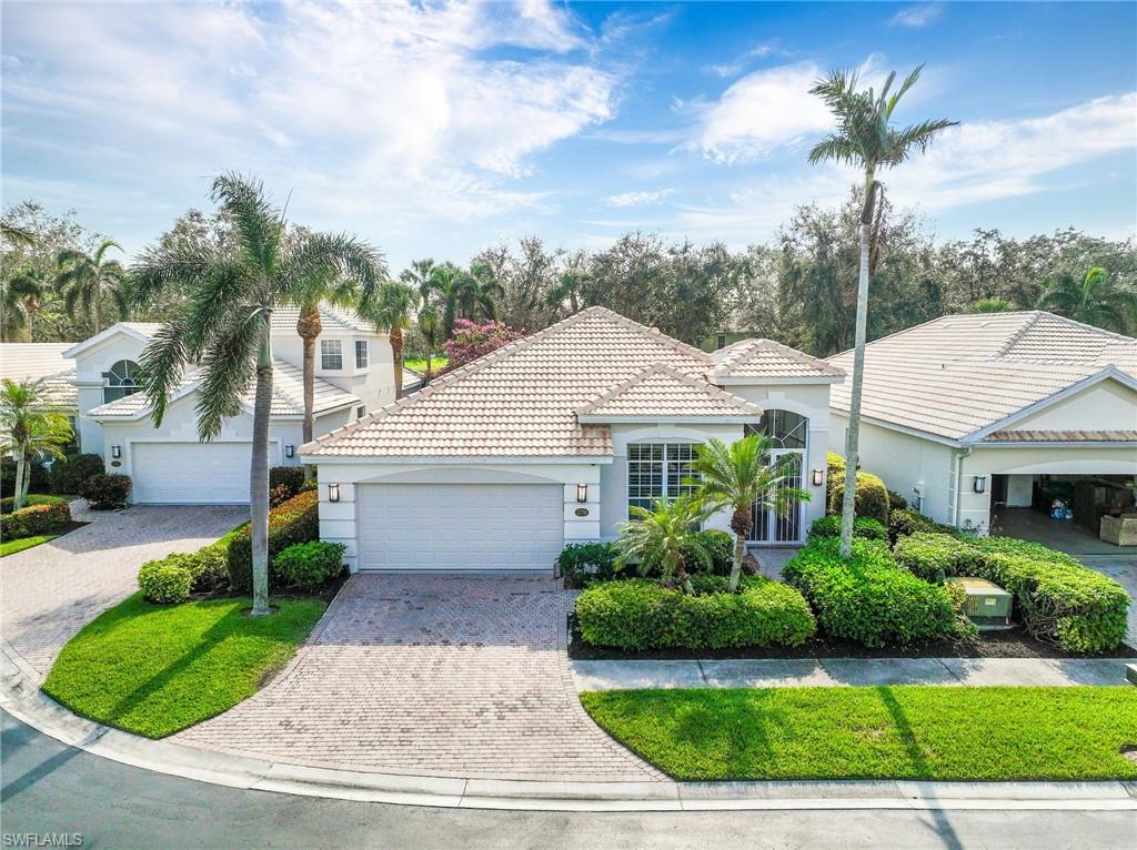 a front view of a house with a garden and plants