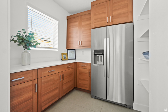 15008 South Springtime Road Draper, UT 84020 - Photo 13 of 37 Kitchen with stainless steel refrigerator with ice dispenser, wood finish cabinets, and light stone countertops