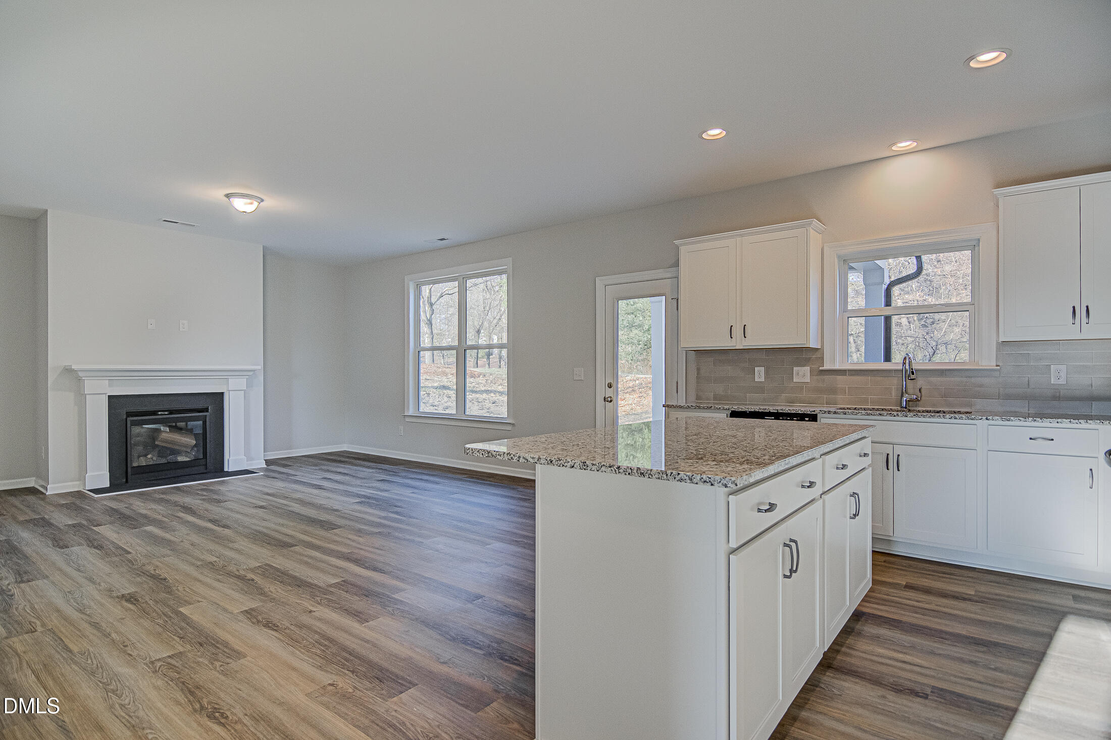 108 Starlet Ridge Way Clayton, NC 27520 - Photo 12 of 37 a kitchen with granite countertop a stove top oven sink and cabinets