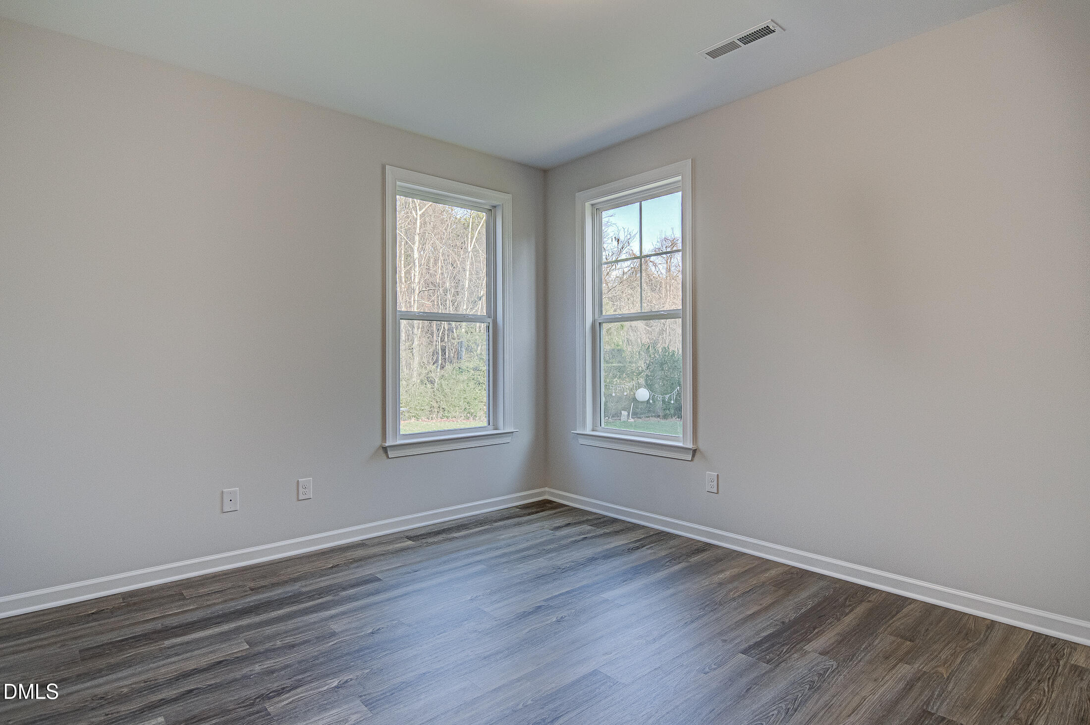 108 Starlet Ridge Way Clayton, NC 27520 - Photo 13 of 37 an empty room with wooden floor and windows