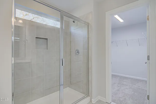 a bathroom with a glass shower door