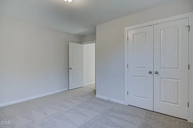 a view of an empty room and closet area