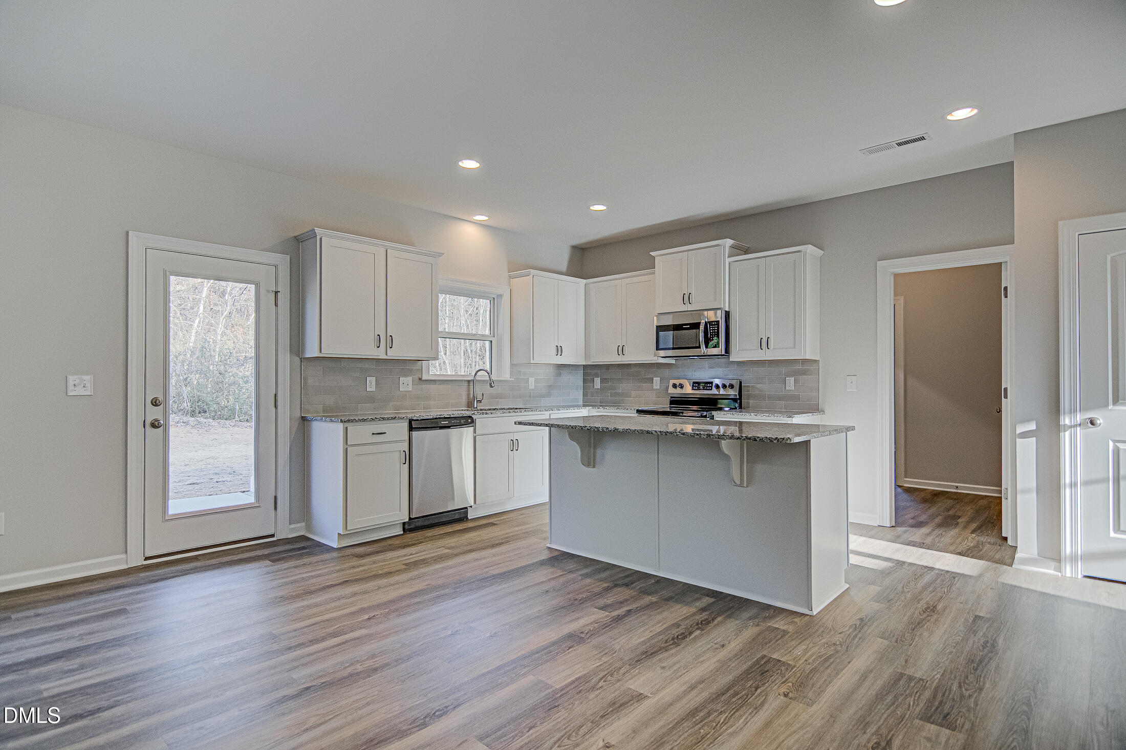108 Starlet Ridge Way Clayton, NC 27520 - Photo 9 of 37 a kitchen with a refrigerator sink and cabinets