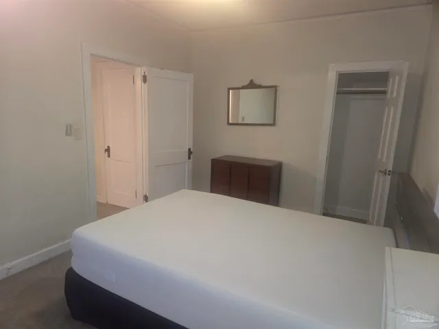 a bedroom with a bed and a closet