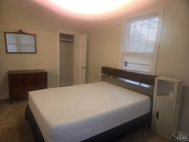 a bedroom with a bed and a desk