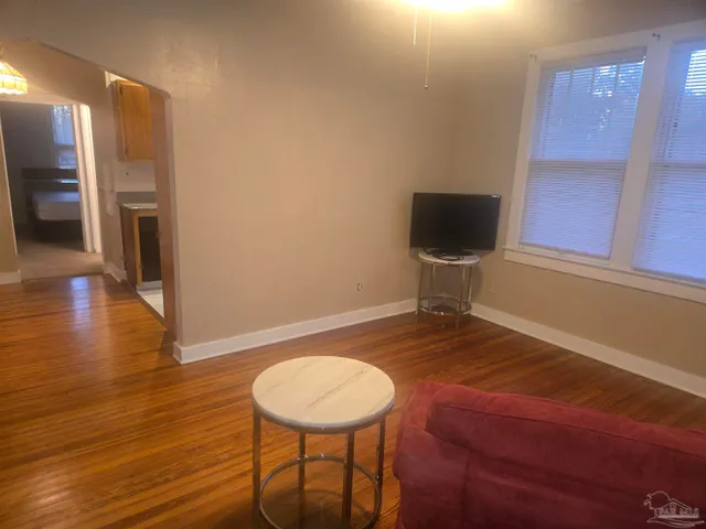 a view of a livingroom with furniture and a flat screen tv