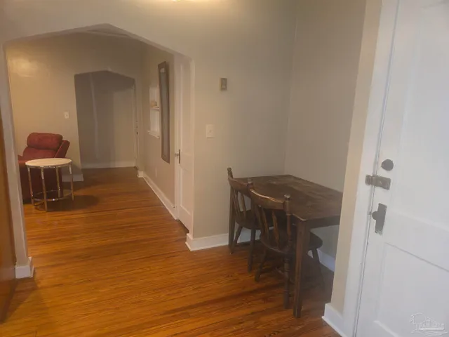 a view of a room with wooden floor and furniture