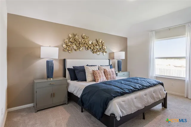 a bedroom with a bed and window