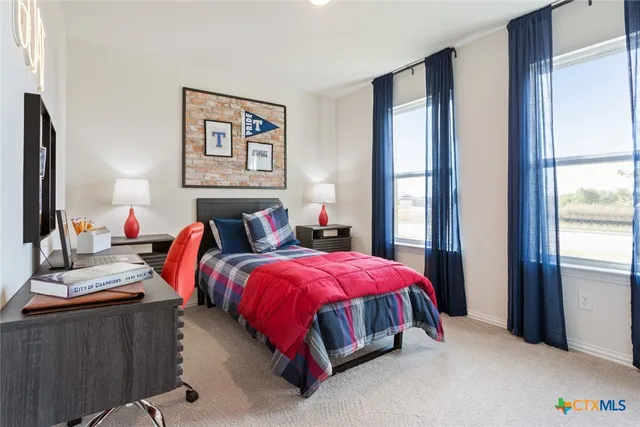 a bed room with two beds and a window