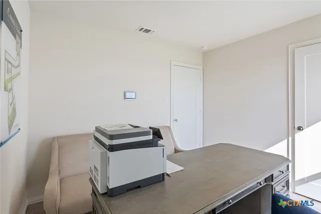 a room with a desk and a workspace