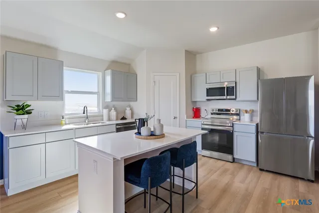 a kitchen with a sink stove and refrigerator