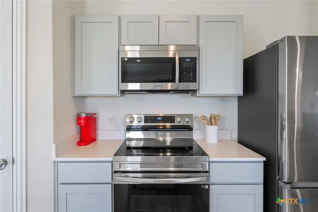 a kitchen with a stove and a microwave