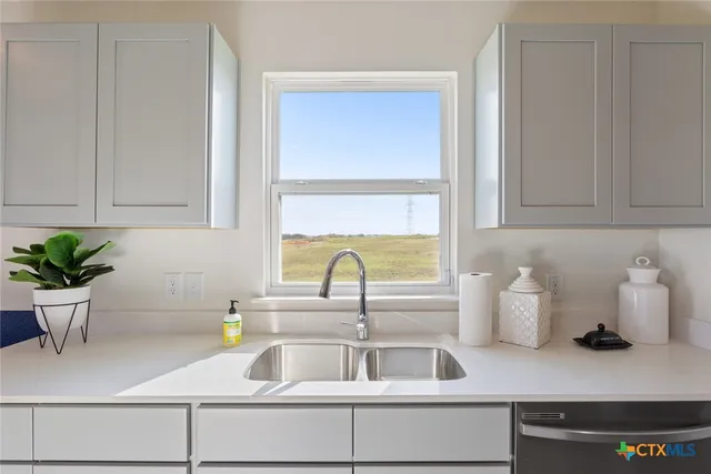 a kitchen with a sink and a window