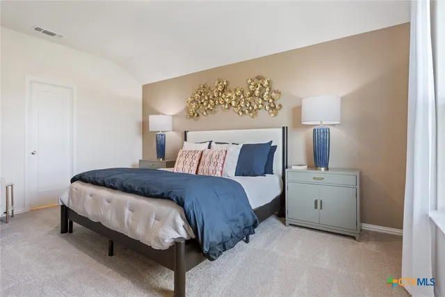 a bedroom with a bed and lamp