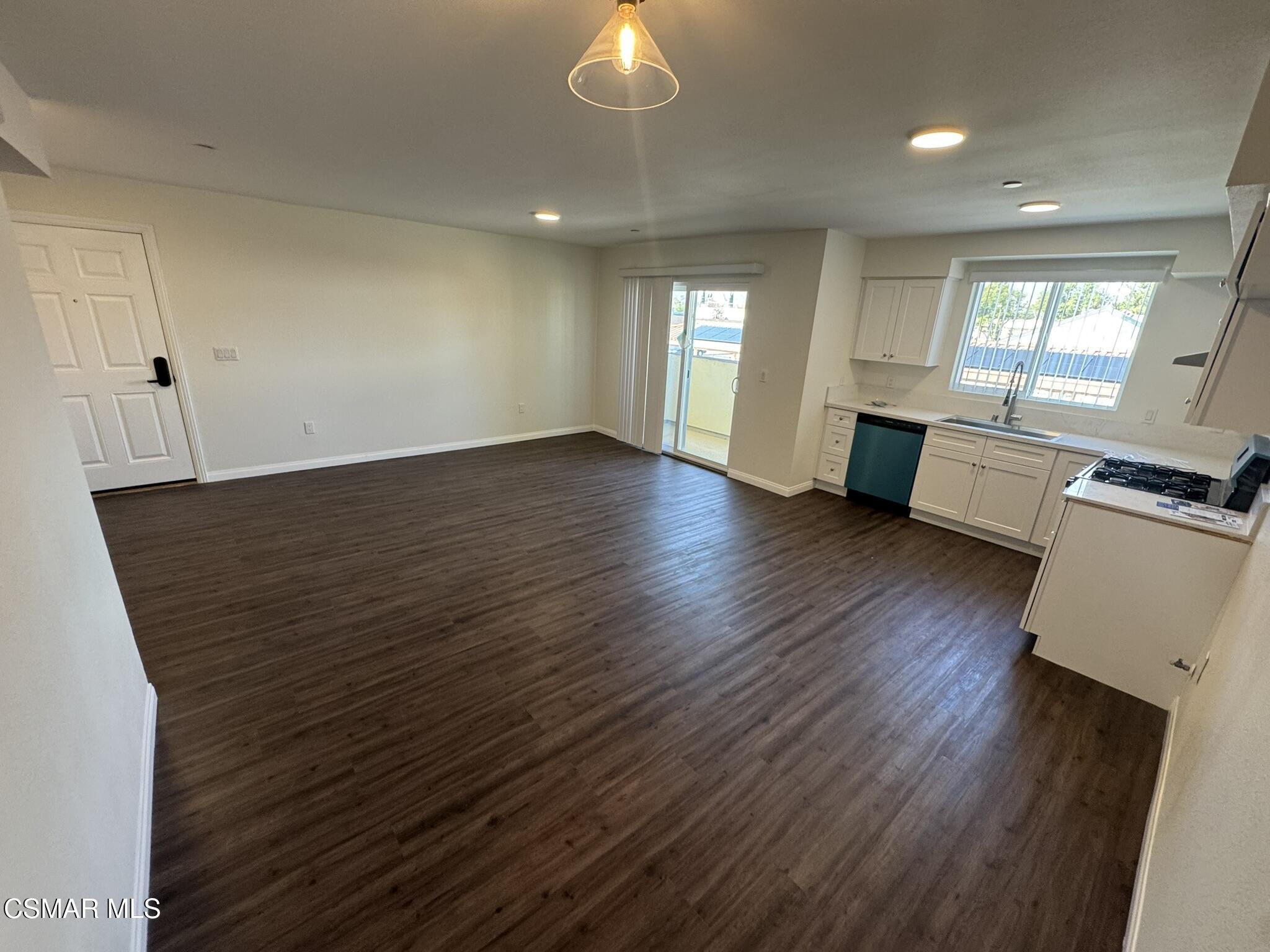 1850 Buyers Street, Unit 202 Simi Valley, CA 93063 - Photo 7 of 15 an empty room with wooden floor and windows