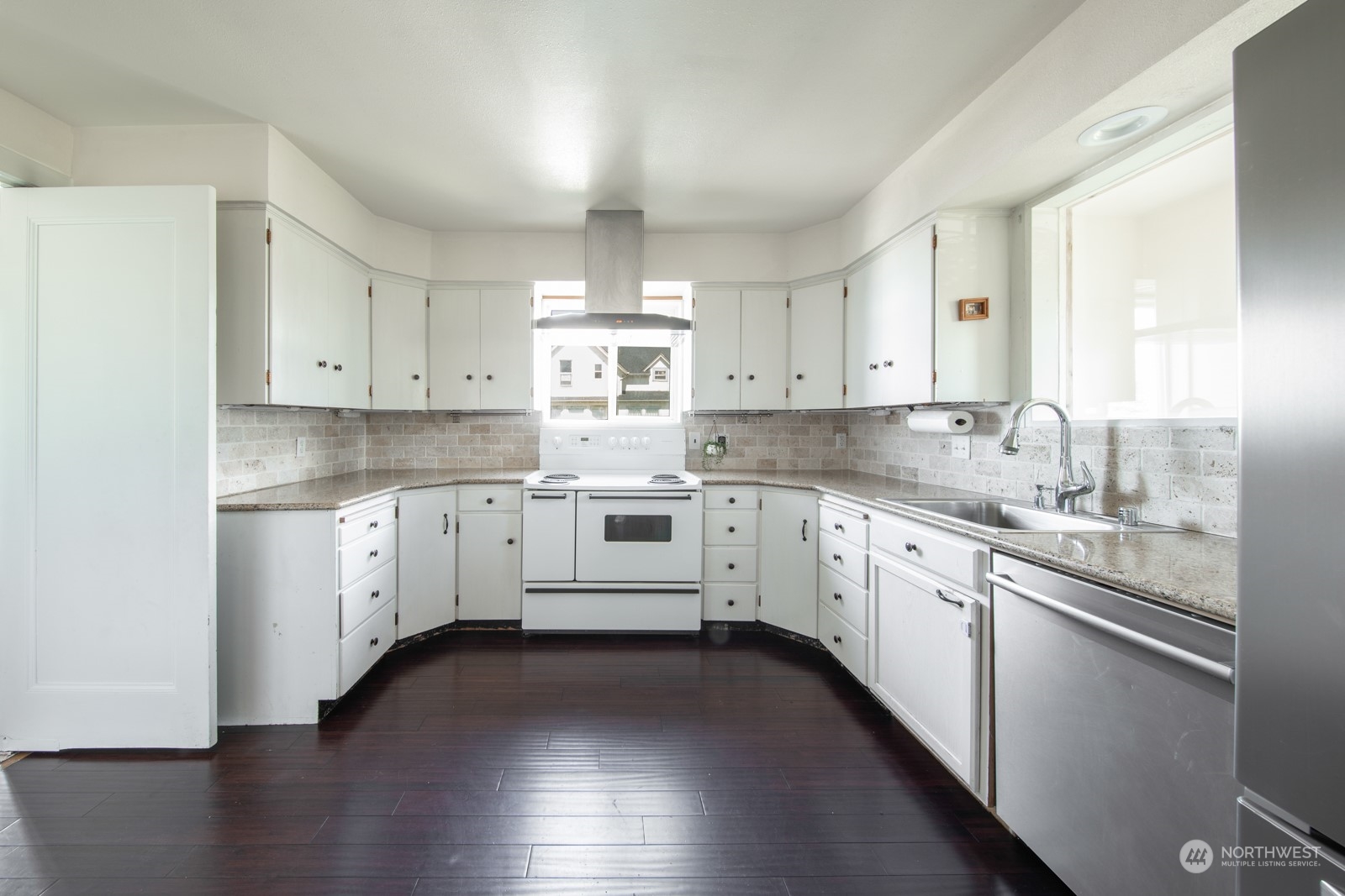2202 Rucker Avenue Everett, WA 98201 - Photo 11 of 37 a kitchen with granite countertop white cabinets and white appliances