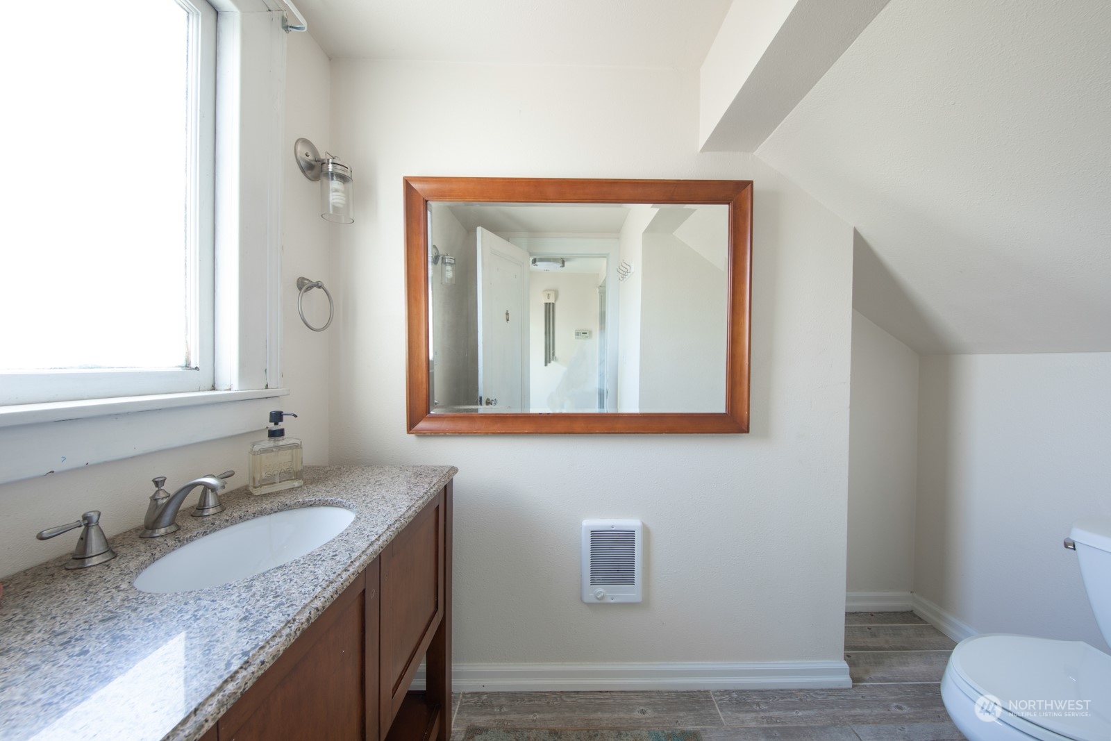 2202 Rucker Avenue Everett, WA 98201 - Photo 12 of 37 a bathroom with a granite countertop sink vanity mirror and toilet