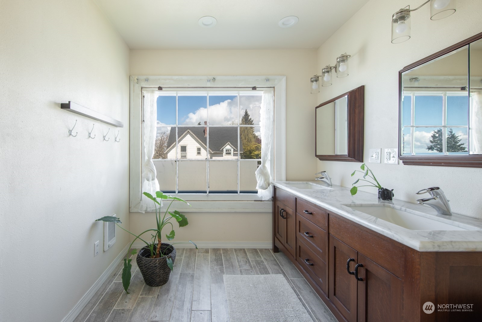 2202 Rucker Avenue Everett, WA 98201 - Photo 20 of 37 a bathroom with a sink a toilet and a mirror