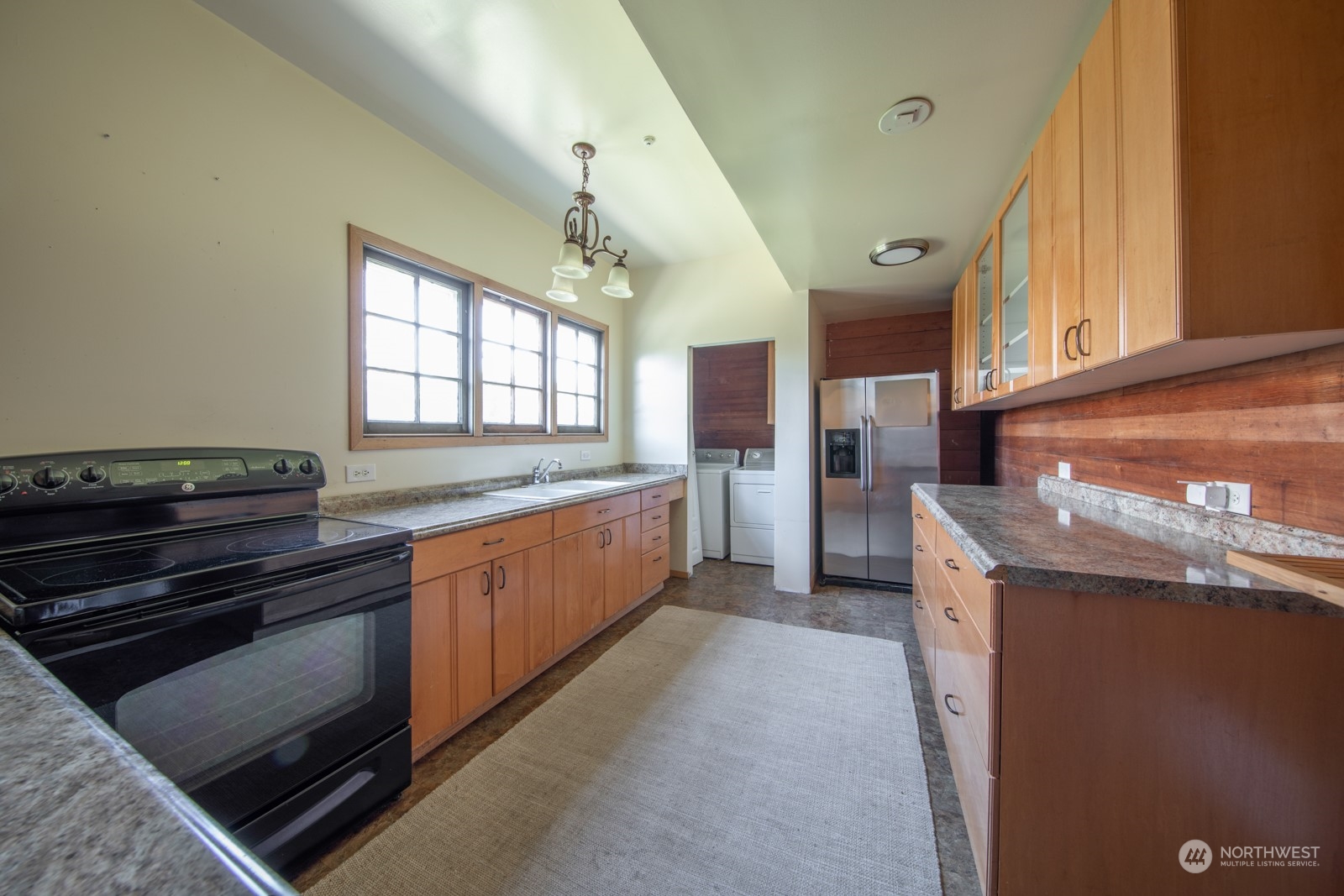2202 Rucker Avenue Everett, WA 98201 - Photo 27 of 37 a kitchen with granite countertop a stove and a sink