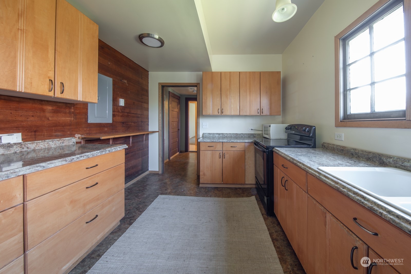 2202 Rucker Avenue Everett, WA 98201 - Photo 28 of 37 a kitchen with granite countertop white cabinets and white appliances