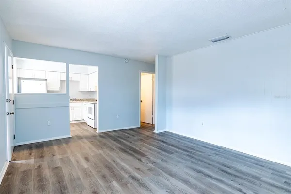a kitchen with white cabinets and white appliances