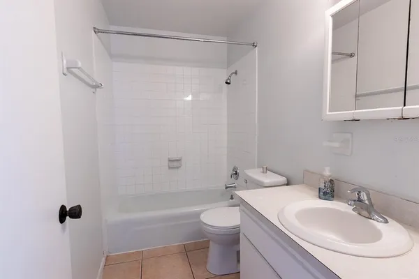 a bathroom with a toilet a sink a mirror and shower