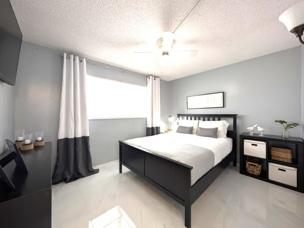 a bedroom with a bed and window